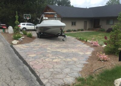 house with a boat on new stone driveway