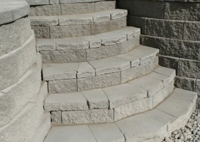 Small stone steps connected to a retaining wall