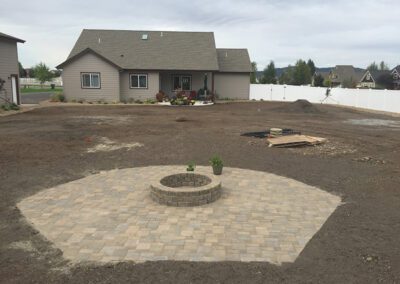 circular stone firepit surrounded by dirt