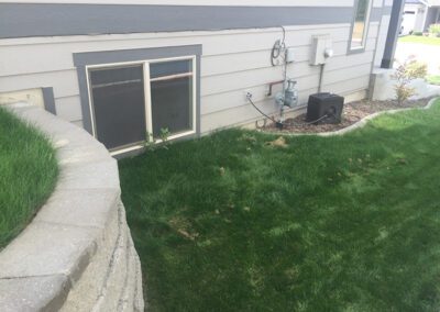 grass lawn next to retaining wall