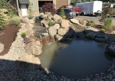 large rock fountain with small pond
