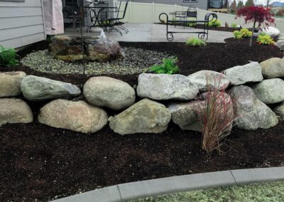 Picture of a small circular rock garden and wall