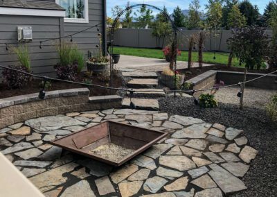 stone pathway way with square fire pit and gravel landscaping