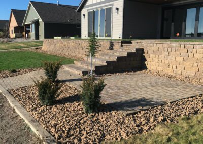 Angled view of stone steps leading up retaining wall